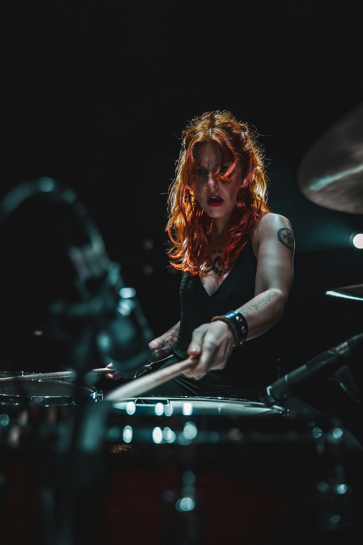 Unsplash: Woman drumming with fiery red hair by jose pinto