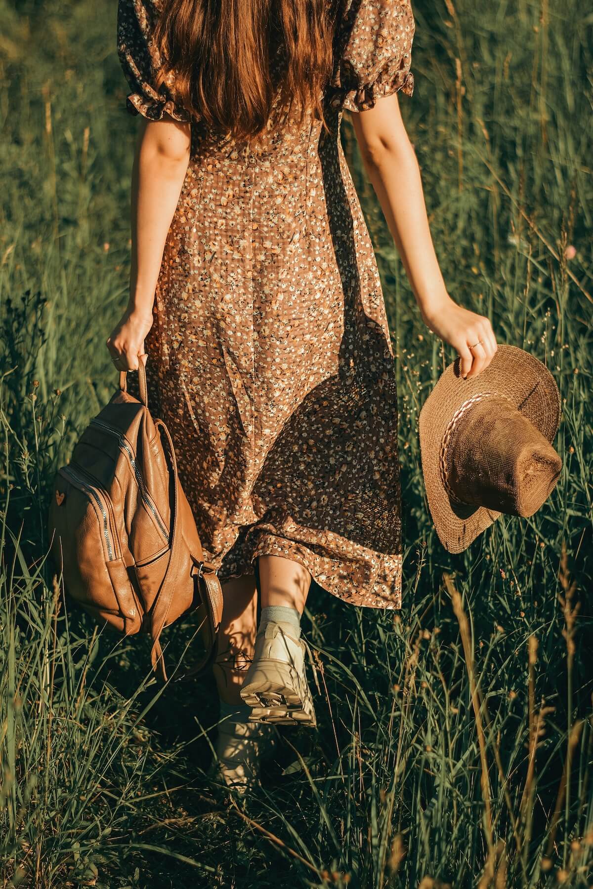Unsplash: Woman in flowy maxi dress and cowgirl hat by Sergey Sokolov