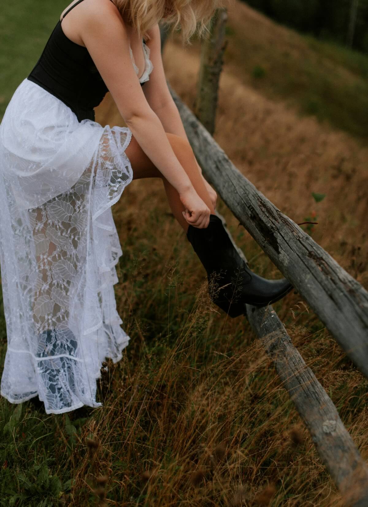 Unsplash: Woman in lace skirt and cowboy boots by Kateryna Hliznitsova