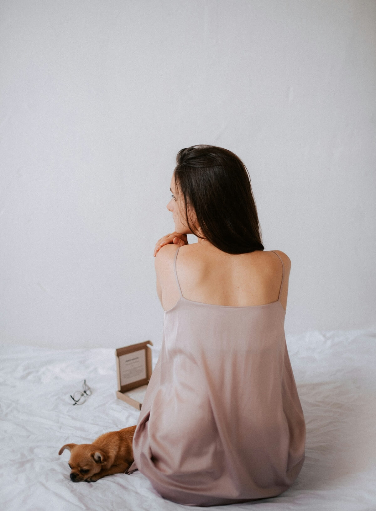 Unsplash: Woman in nightgown with dog by Kateryna Hliznitsova