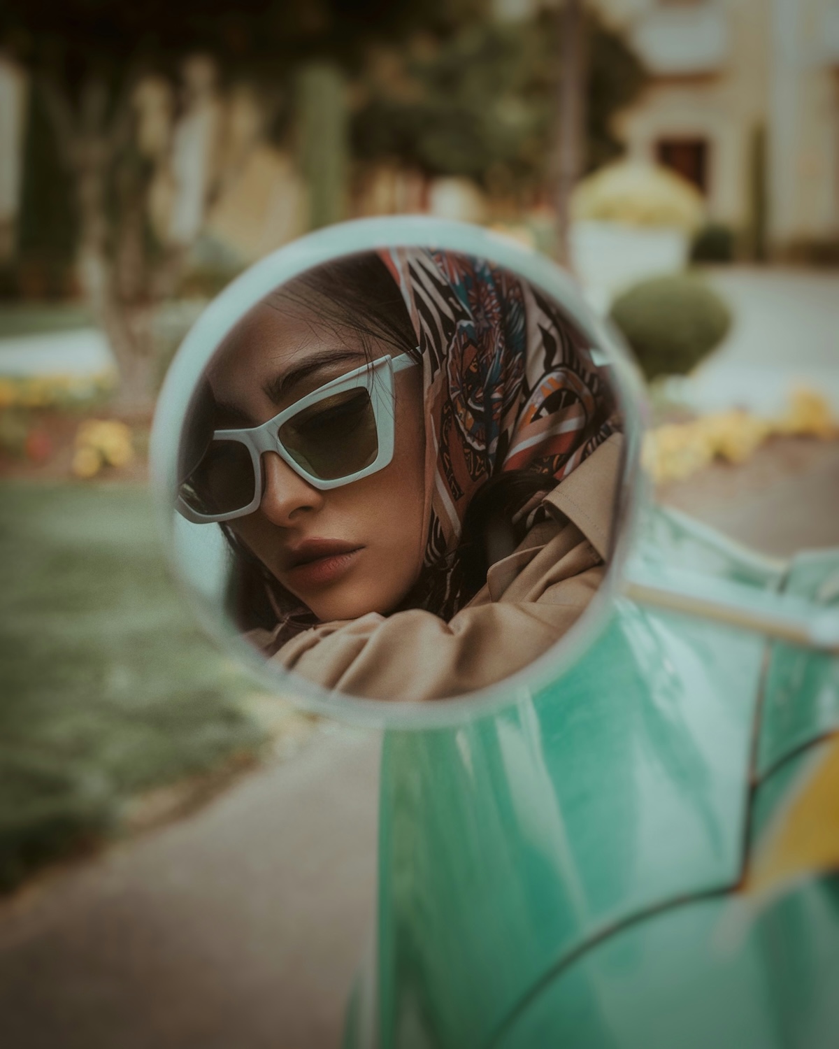 Unsplash: Woman with angular sunglasses looking in mirror by Lance Reis