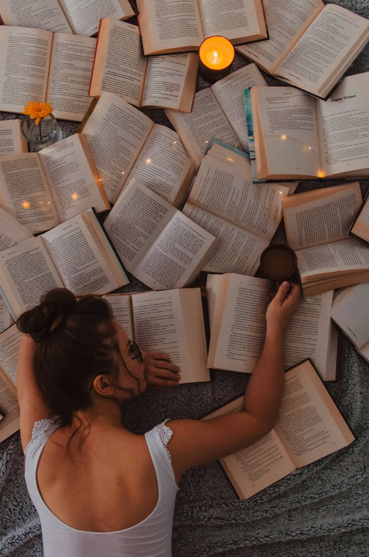Unsplash: Woman with mess of books by Gaman Alice