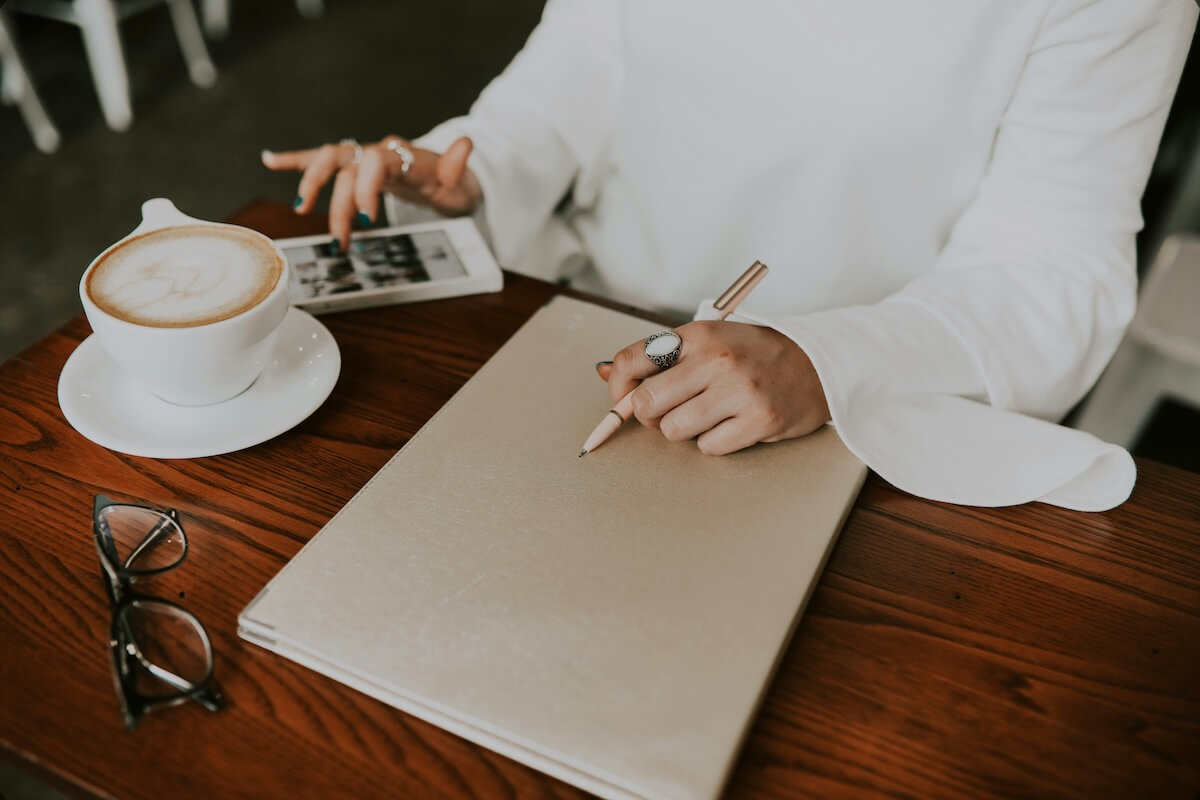Unsplash: Woman working from coffee shop by Emma Dau