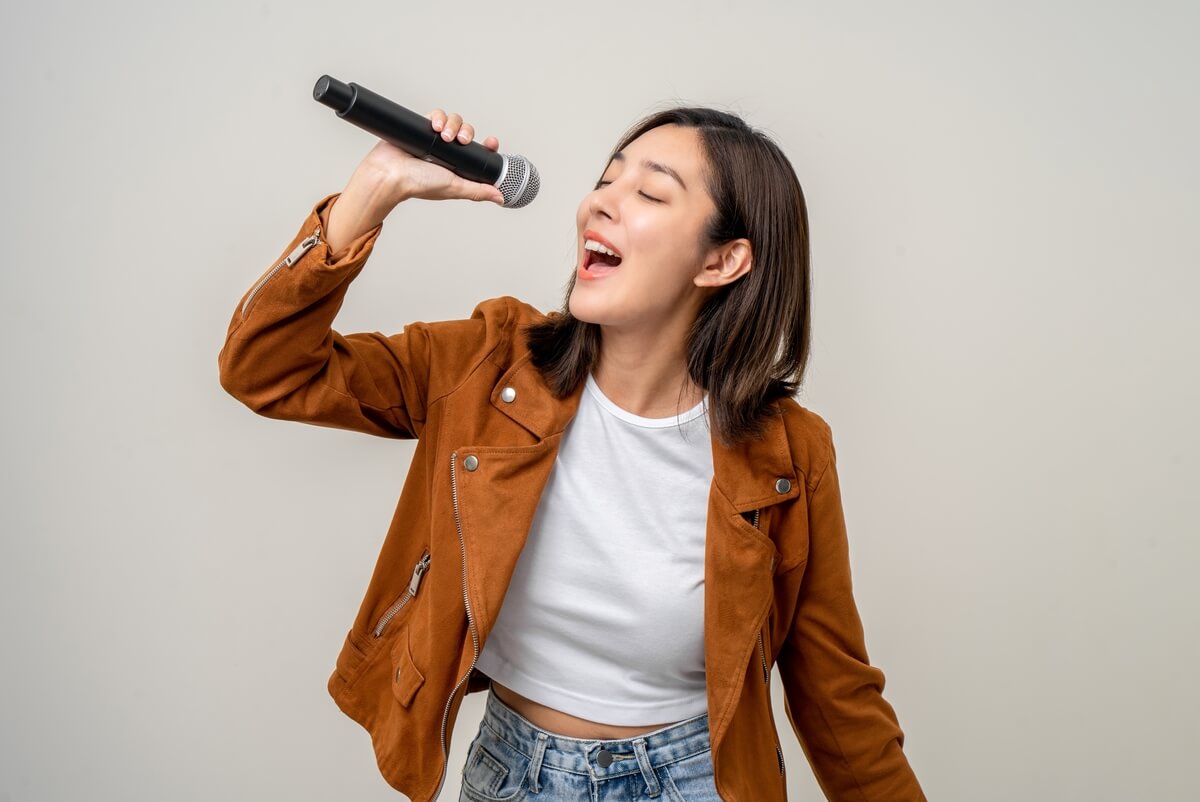 woman singing into microphone