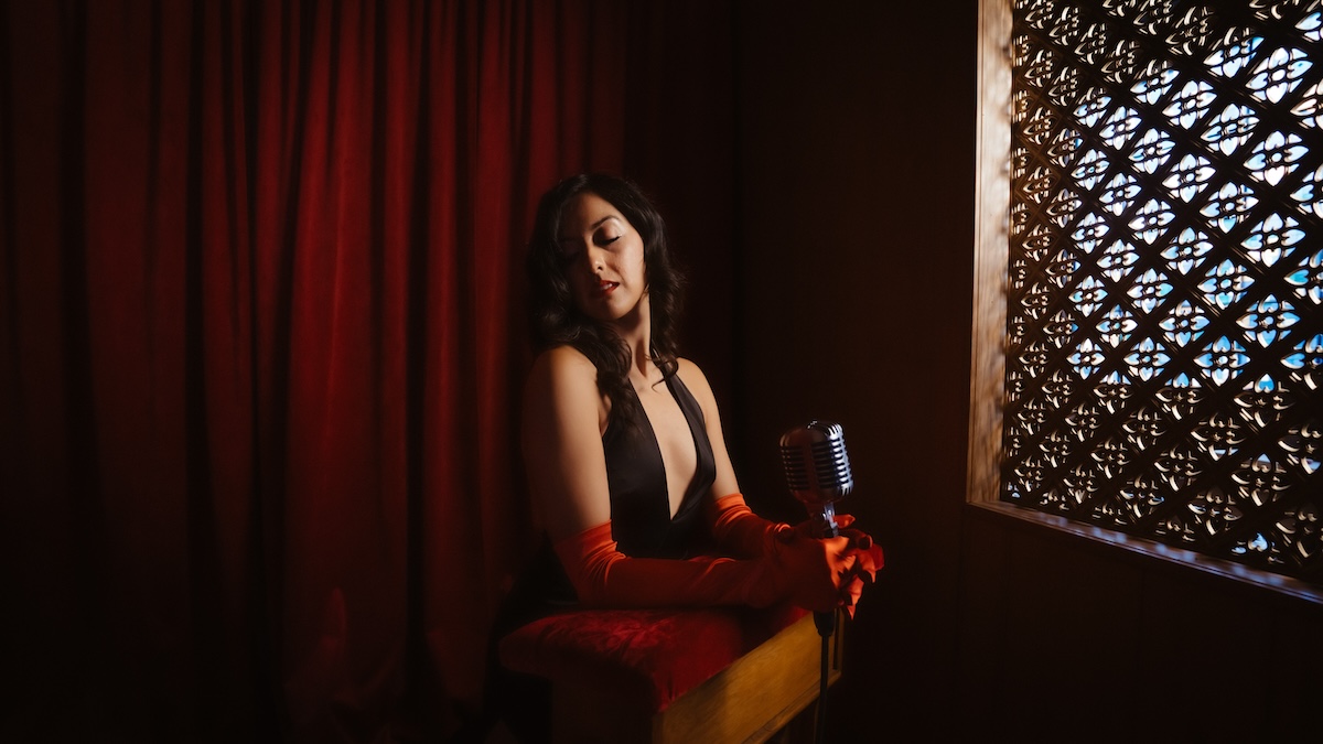 Lauren Vahdani: Playing the Fool Promo image with mic