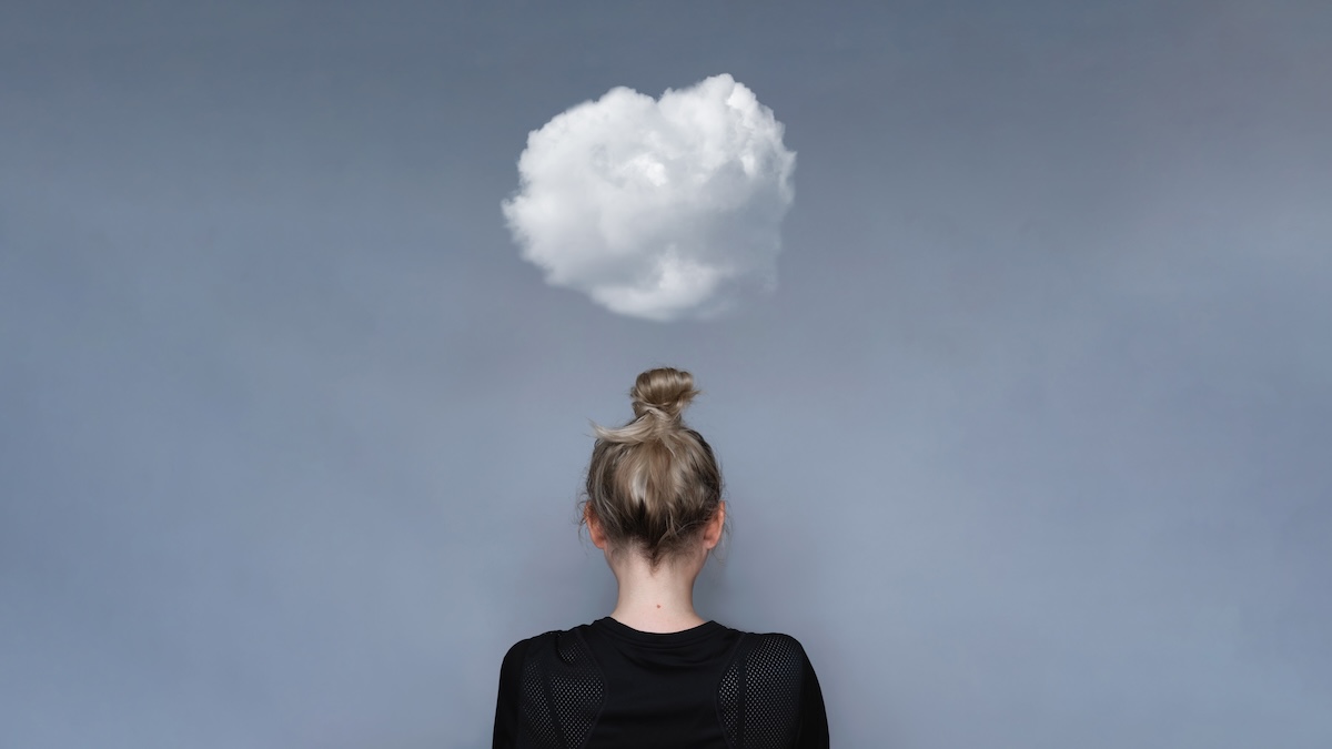 Shutterstock: Young girl simple hairstyle back view with cloud above her head. Depression, loneliness and quarantine concept. Fashion model, trendy woman. Mental health metaphor concept
