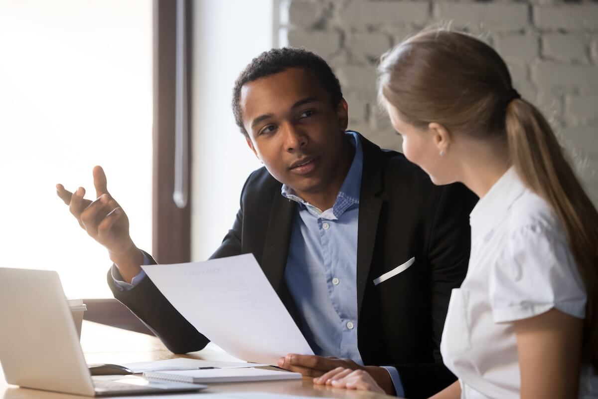 Shutterstock: African american boss negotiating discussing contract details with company corporate woman client. Black hr manager interviewing young female job candidate. Employment hiring human resources concept
