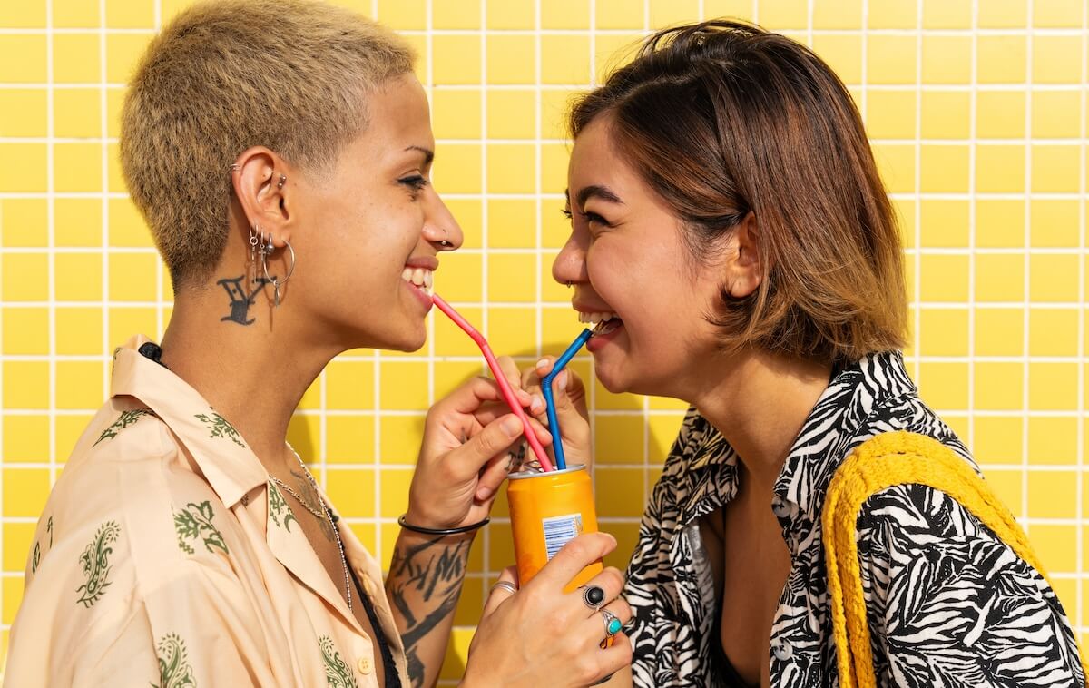 Shutterstock: Beautiful multiethnic lesbian couple of lovers dating outdoors - LGBT people bonding and spending time together, concepts about LGBTQ community, diversity, love and lifestyle