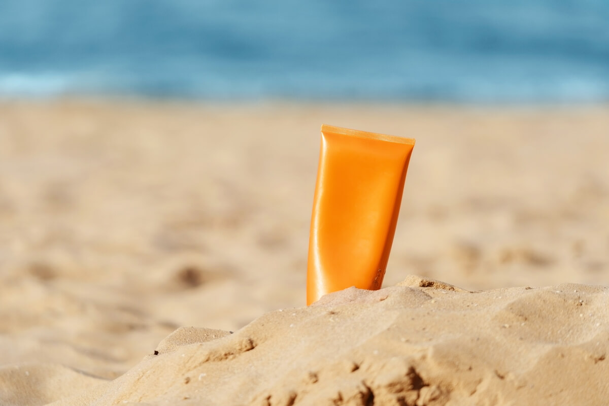 sunscreen bottle in the sand