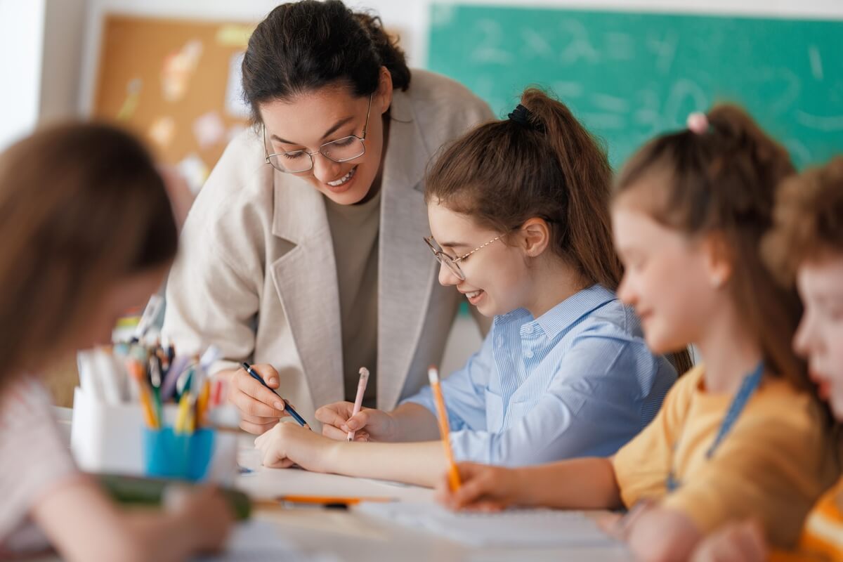 teacher smiling with students