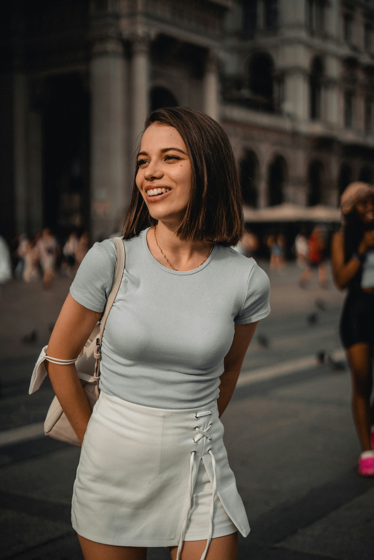 Unsplash: Smiling approachable woman in city by yurii papushoi