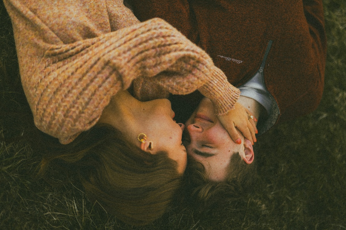 Unsplash: Couple being loving in grass by Brooke Balentine