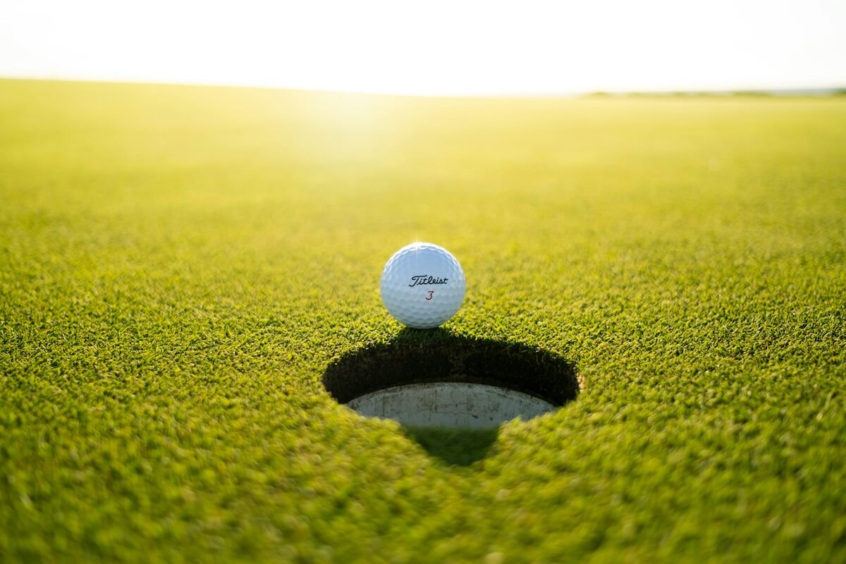 Unsplash: Golf ball next to hole by Soheb Zaidi Awin