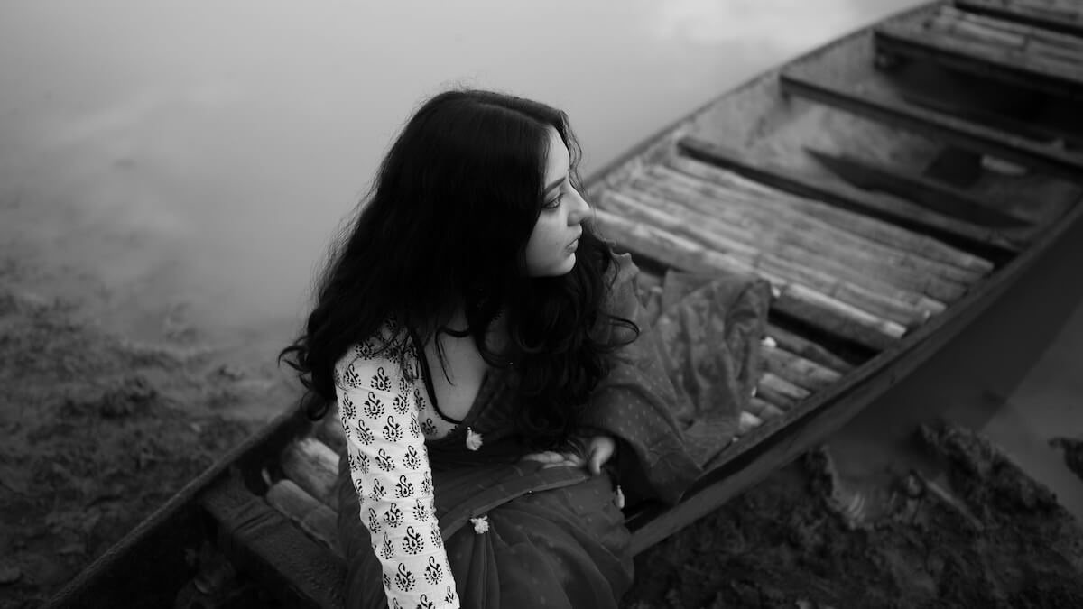 Unsplash: Thoughtful woman in boat in black and white by Shiv Naraylan Das