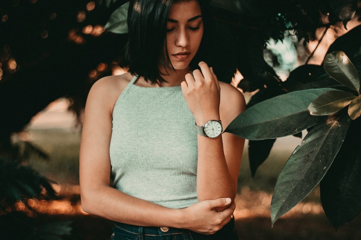 Unsplash: Thoughtful woman looking at watch by Allef Vinicius