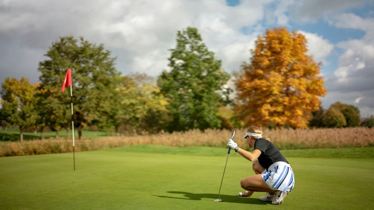 Unsplash: Woman preparing to putt on golf course by Frederik Rosar