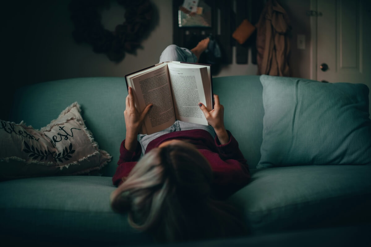 Unsplash: Woman reading on couch upside down by Matias North