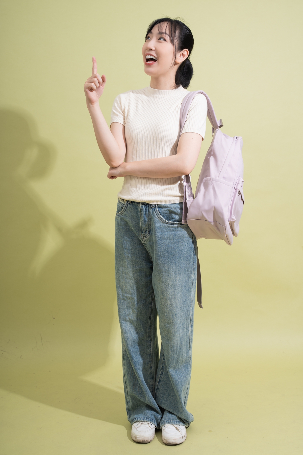 happy young woman with baggy jeans