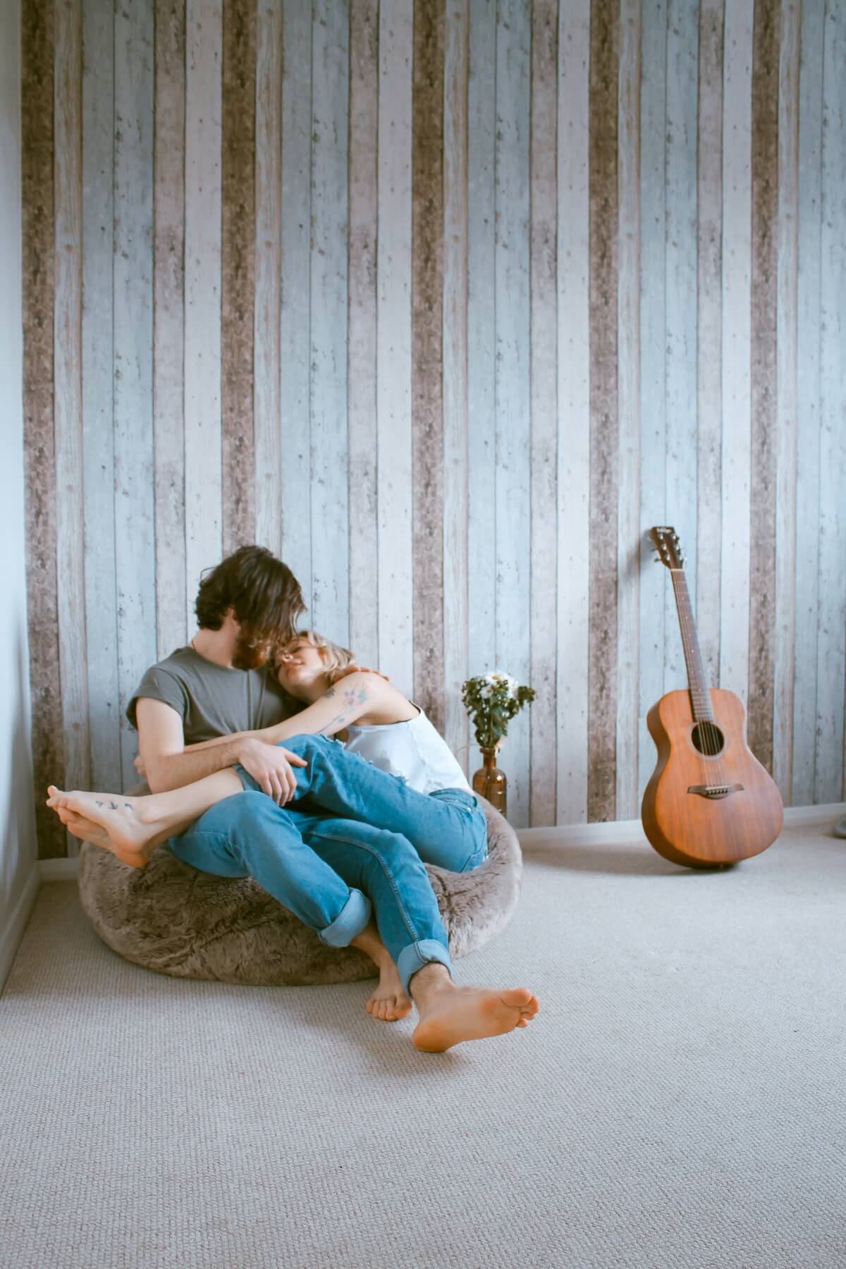 Unspash: Couple sitting on bean bag chair in a romantic pose by Toa Heftiba