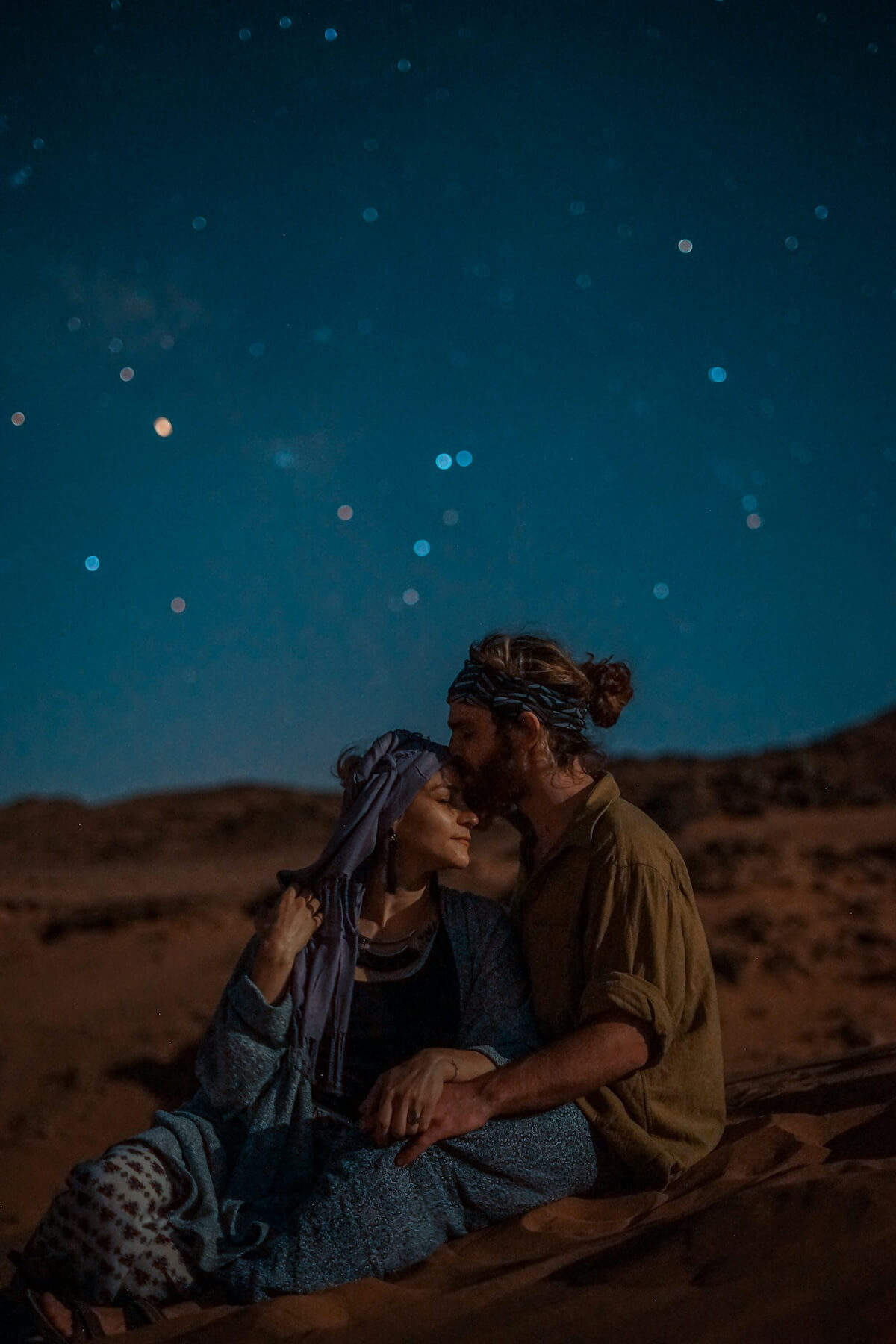 Unsplash: Couple sitting under the night sky by Toa Heftiba