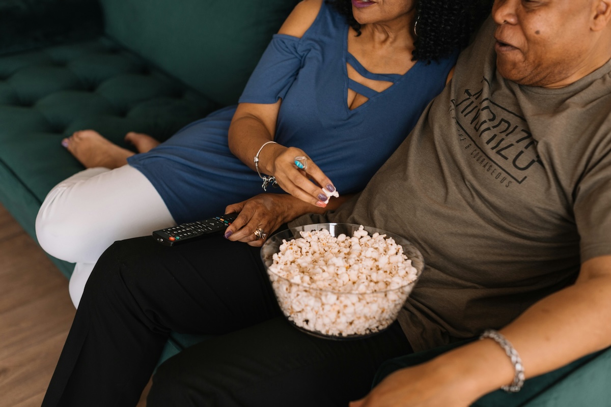 Unsplash: Couple watching movie together with popcorn by Phillip Goldsberry