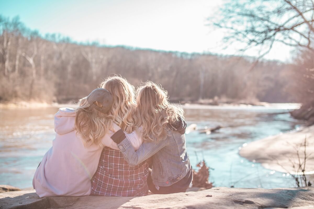 Unsplash: Friends sitting around riverbank by Courtney Cook