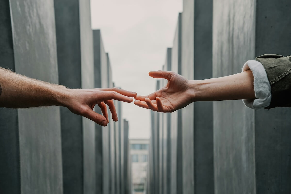 Unsplash: Hands reaching out and touching - empathy by Toa Heftiba