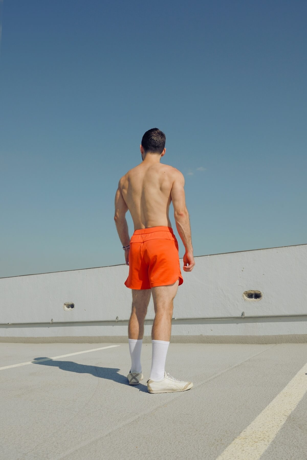 Unsplash: Man in orange shorts by Aram