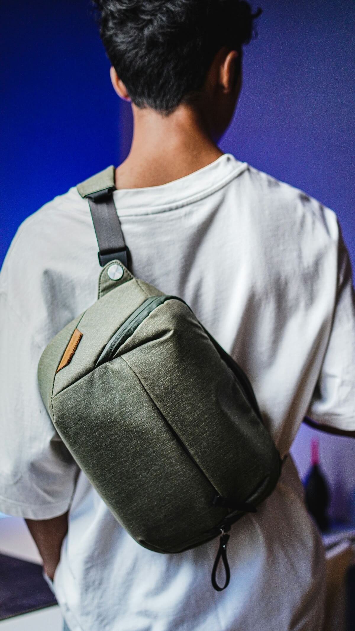 Unsplash: Man wearing green sling bag by Dhehaivan