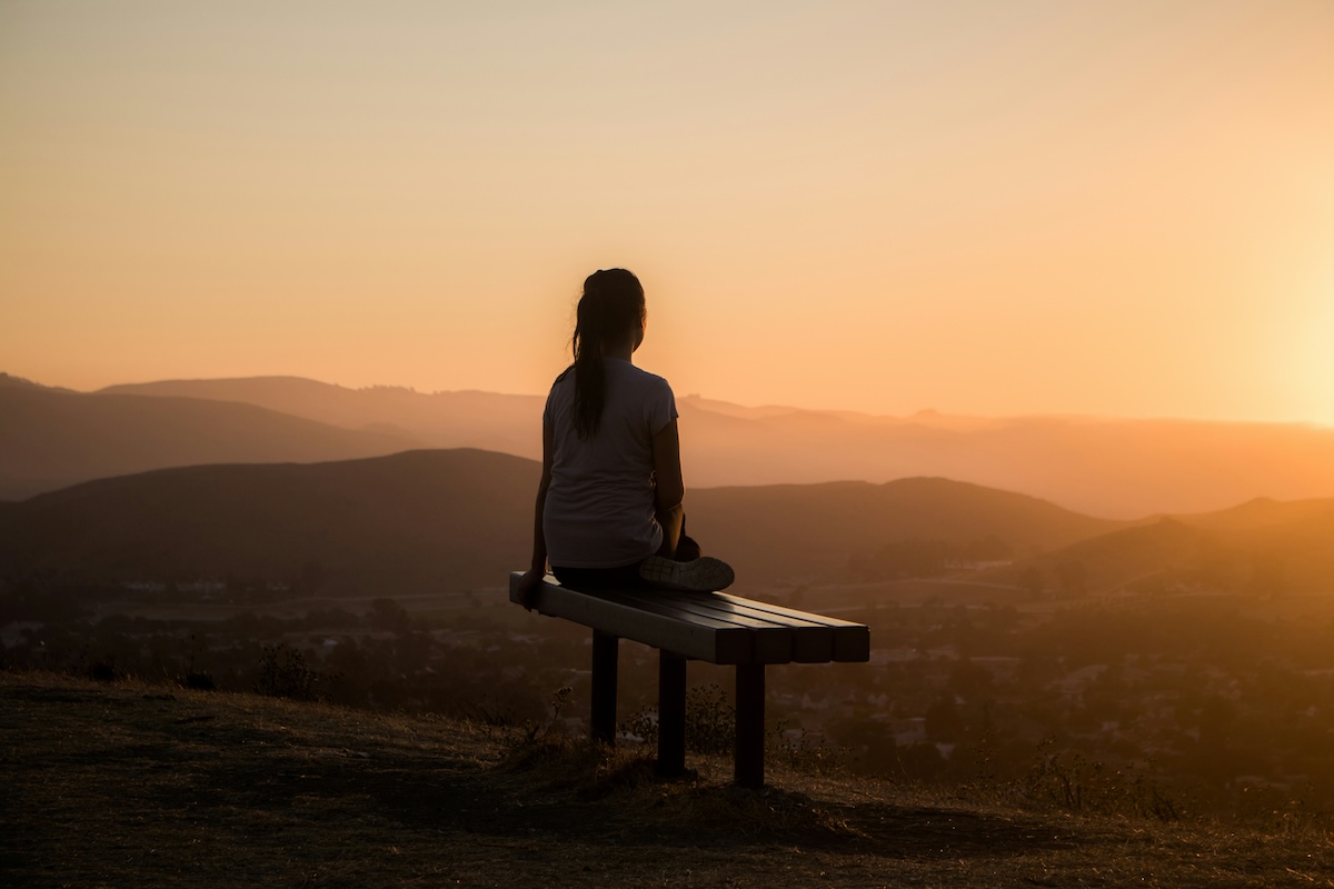 Unsplash: Woman being mindful on hiking bench by Sage Friedman
