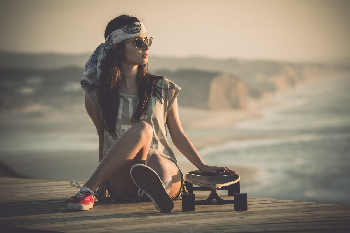 woman sitting with skateboard