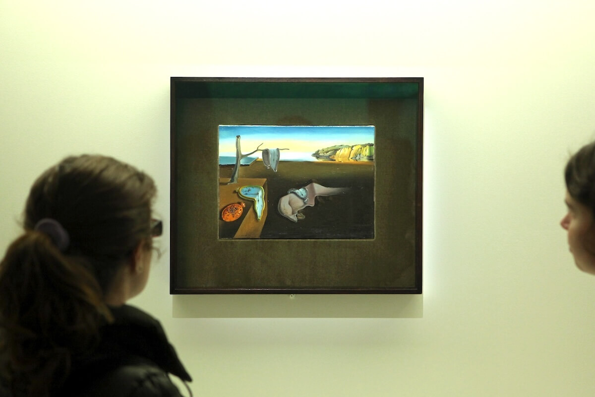 Shutterstock: PARIS, FRANCE - JANUARY 7, 2013: Visitors look at the painting The Persistence of Memory (1931) by Salvador Dali displayed at his retrospective exhibition in Paris, France.