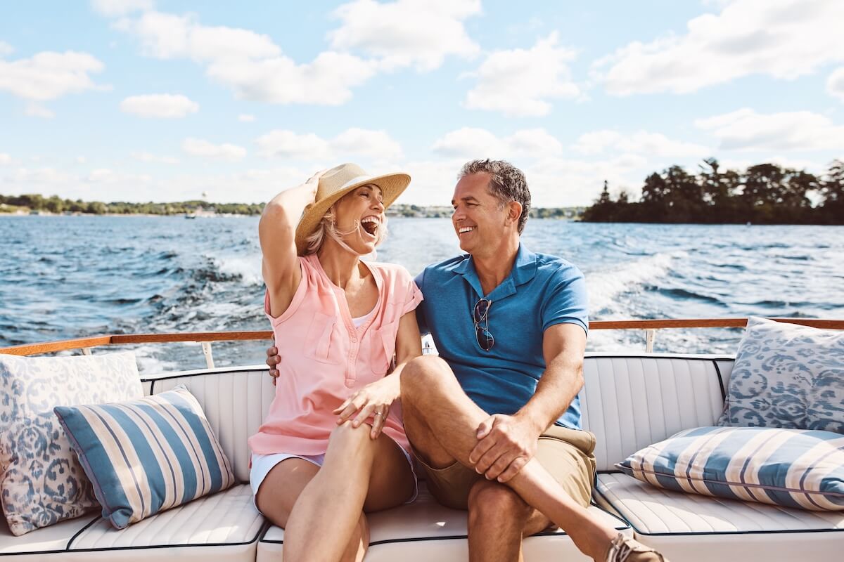 Shutterstock: Laughing, happy couple and on a boat for retirement travel, summer freedom and holiday in Bali. Smile, love and a senior man and woman on a yacht for vacation adventure, luxury and a cruise date