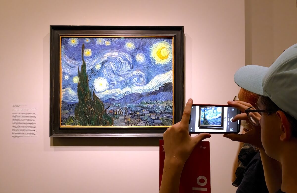Shutterstock: New York City, USA - August 22, 2023: Tourist photographing a famous painting by Van Gogh