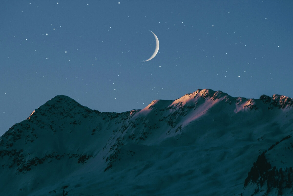 Unsplash: Crescent moon above mountaintops by benjamin voros