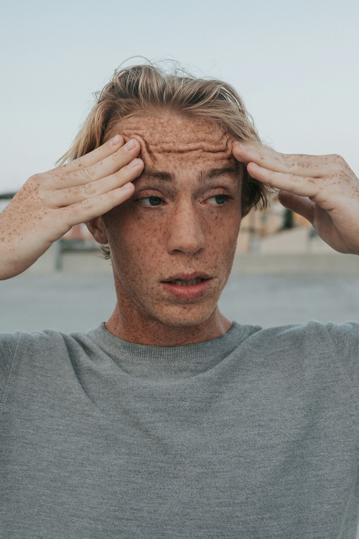 Unsplash: Stressed man with head on desk by Vitaly Gariev