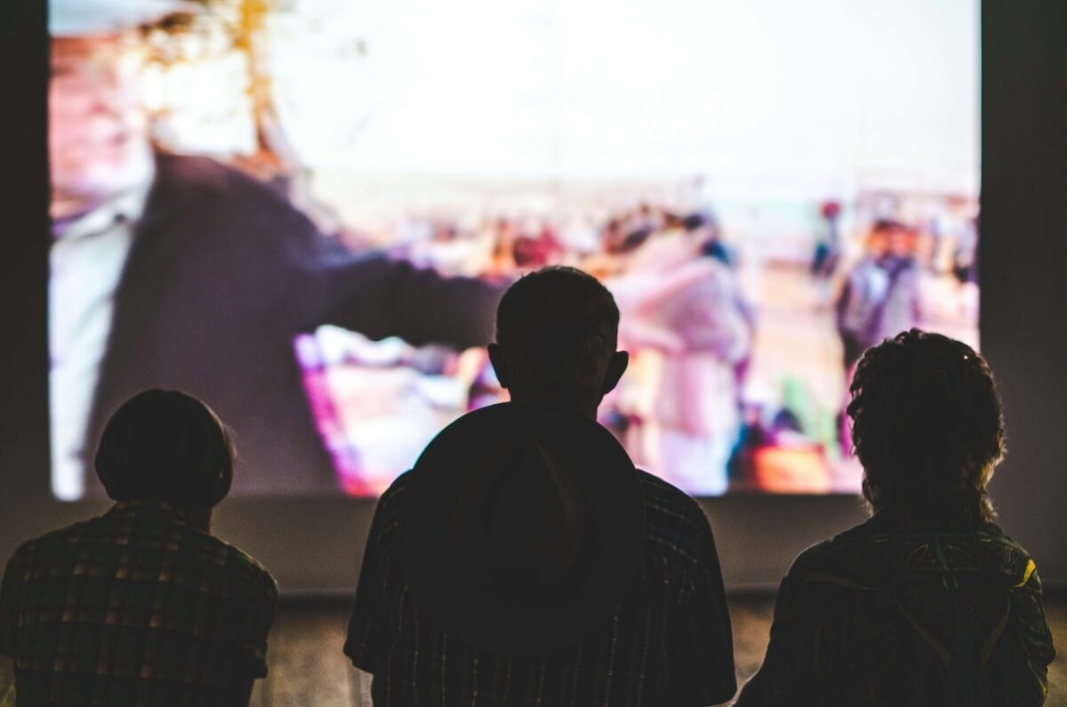 Unsplash: people watching movie on screen by antea pawlik