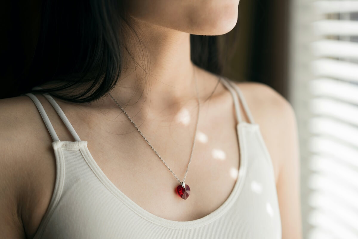 Unsplash: Woman wearing ruby necklace pendant by Pat Kwon