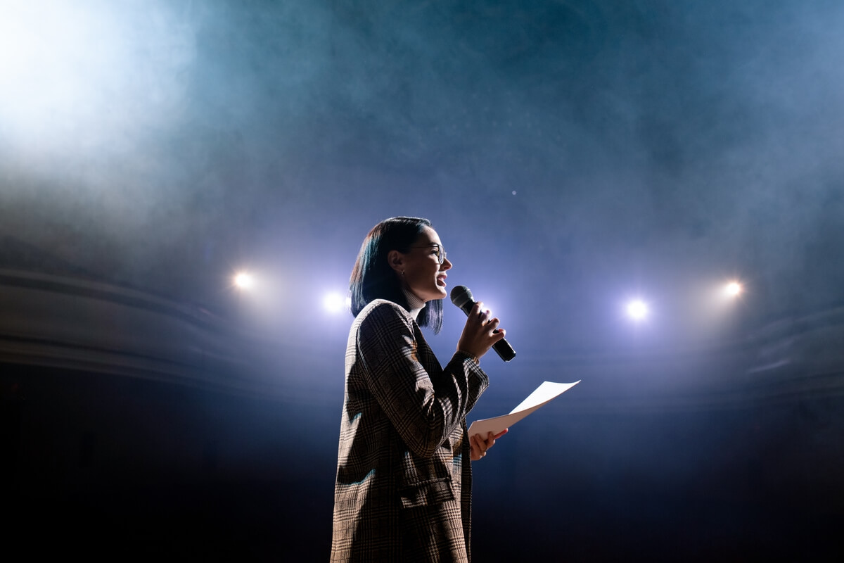 young woman with notes for speech