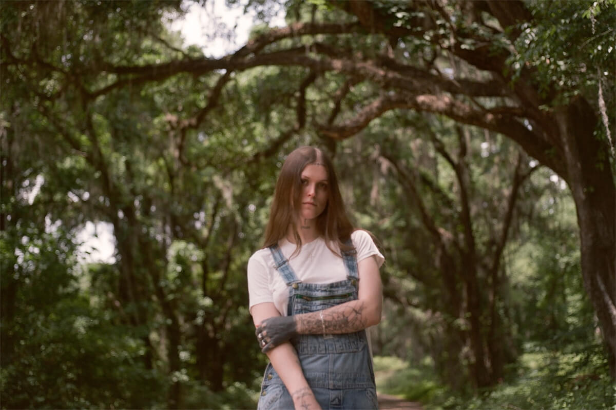 Ethel Cain 'Willoughby Tucker' press image in overalls