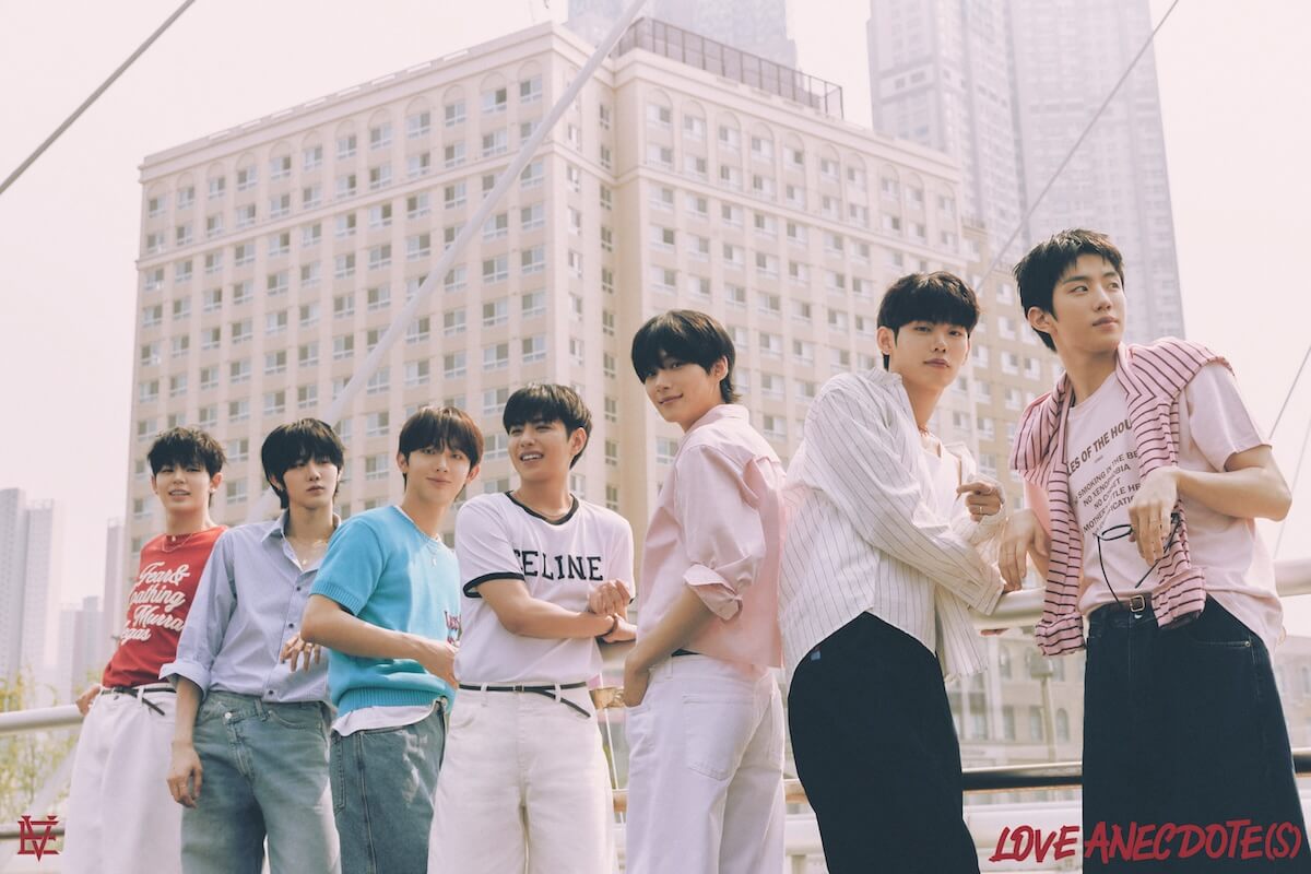 EVNNE Love Anecdote(s): Group shot against city buildings