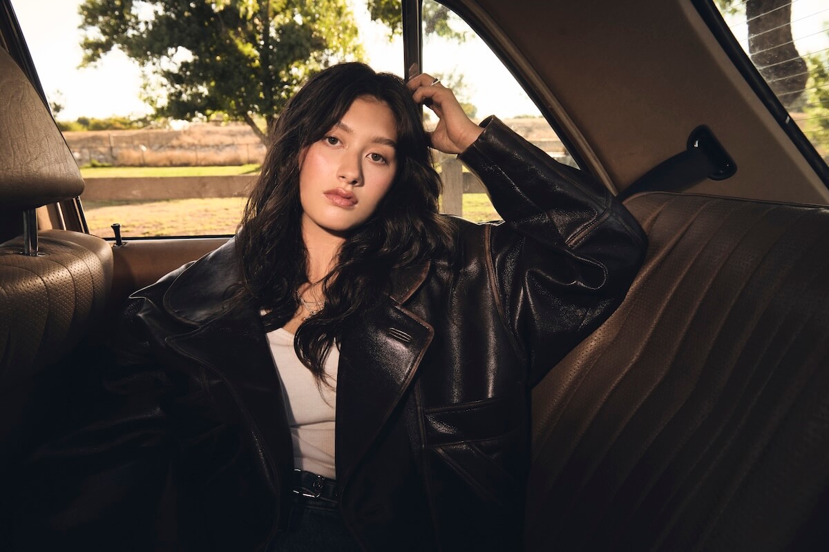 Jade LeMac in leather jacket in back of car