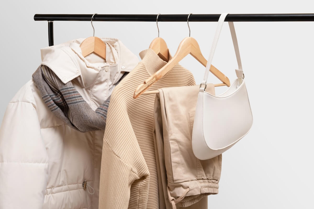 Shutterstock: Basic autumn women's wardrobe concept on railing in showroom. Woman collection of clothes on a rack. Autumn fashion trending concept. Railing with stylish female clothes, clothing retails concept.