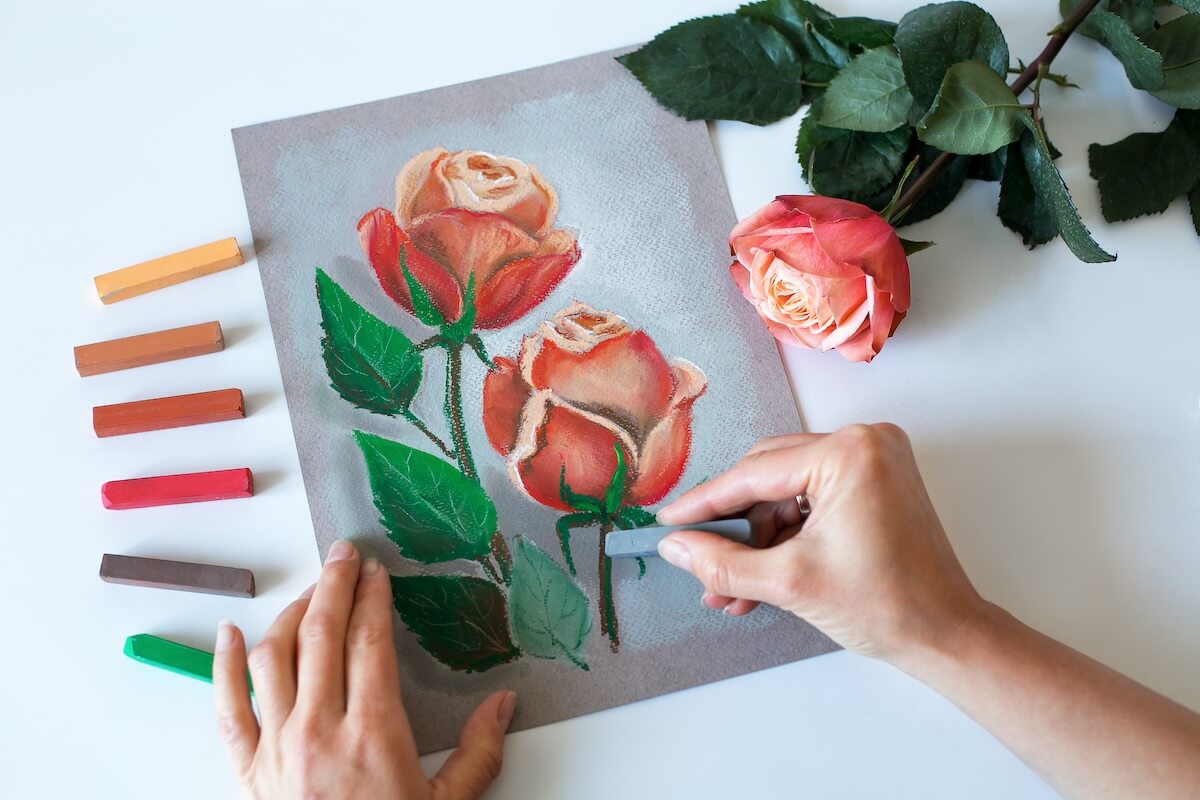 Shutterstock: Painting at home. Soft pastel painting of roses. Top view.