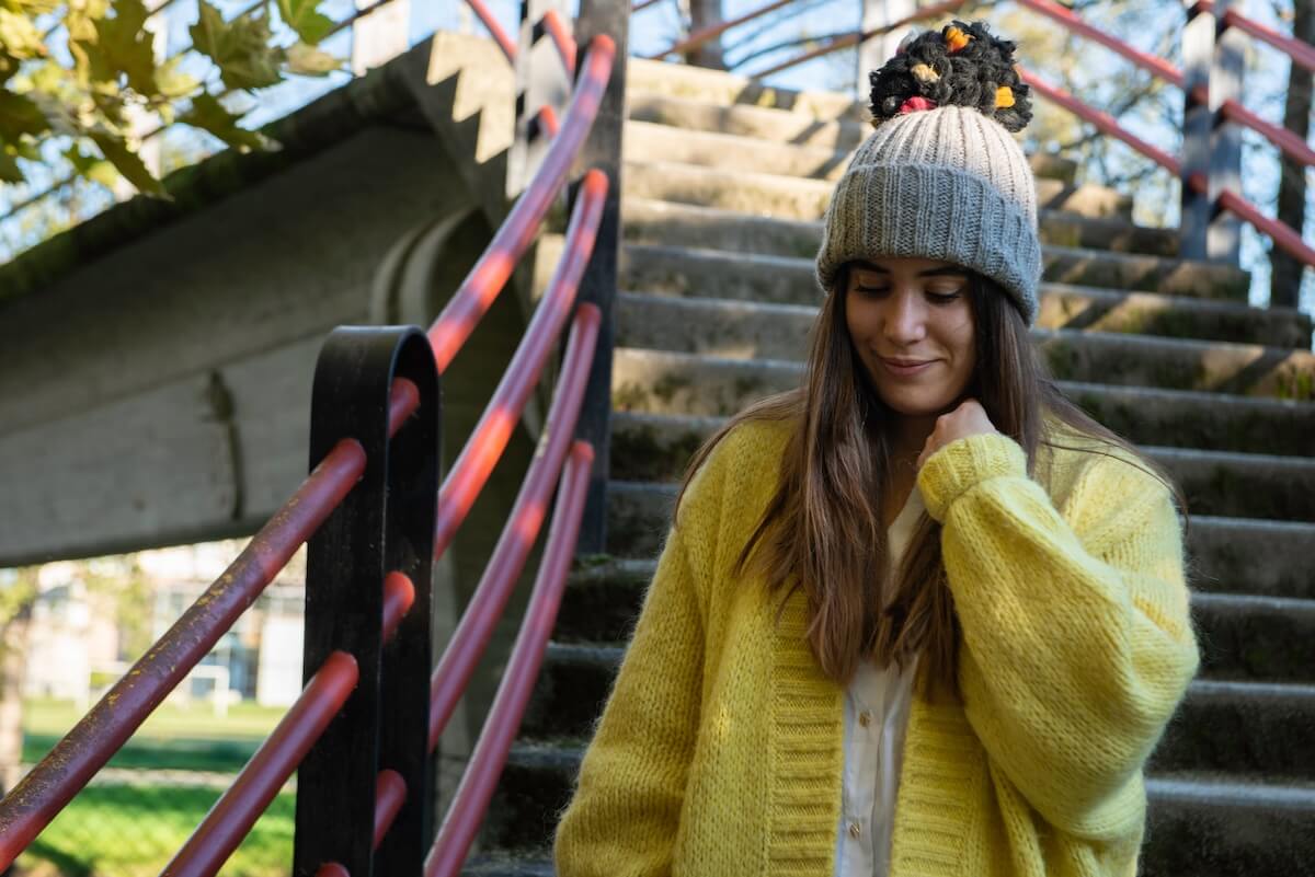 Shutterstock: shy woman touching her hair