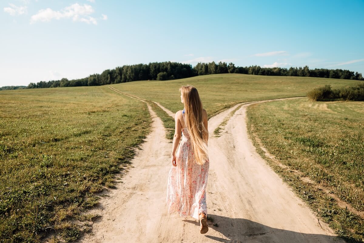Shutterstock: woman in front of two roads thinking deciding hoping for best taking chance