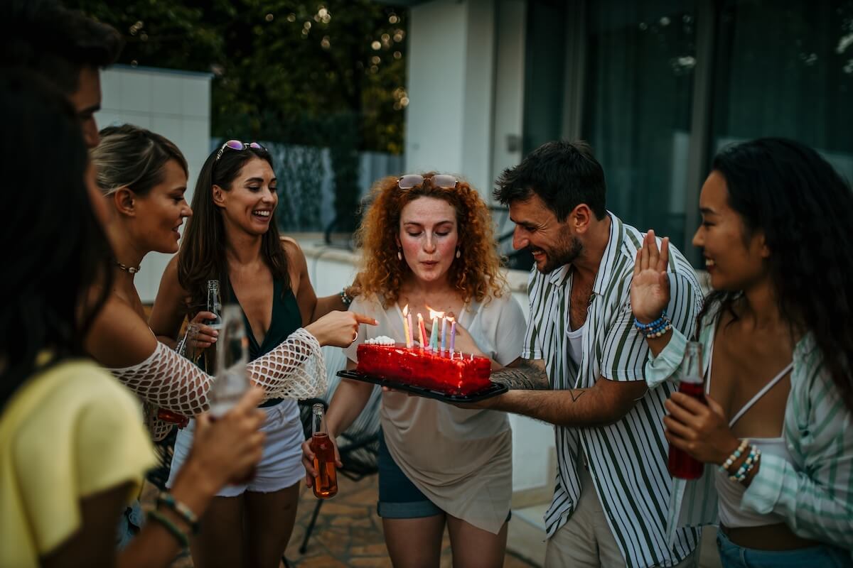 Shutterstock: Group of friends celebrating a birthday together. Party, holidays, happiness, fun and people concept