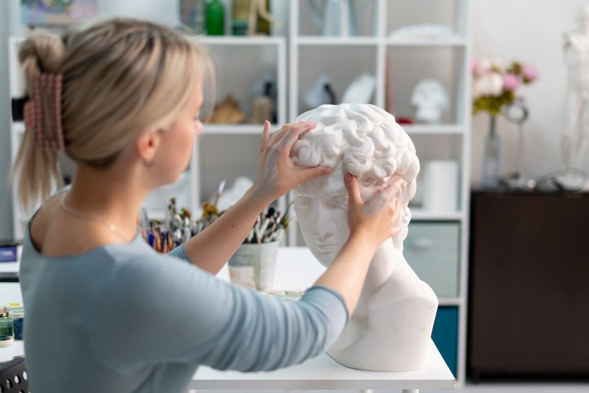 Shutterstock: young female sculptor making gypsum sculpture