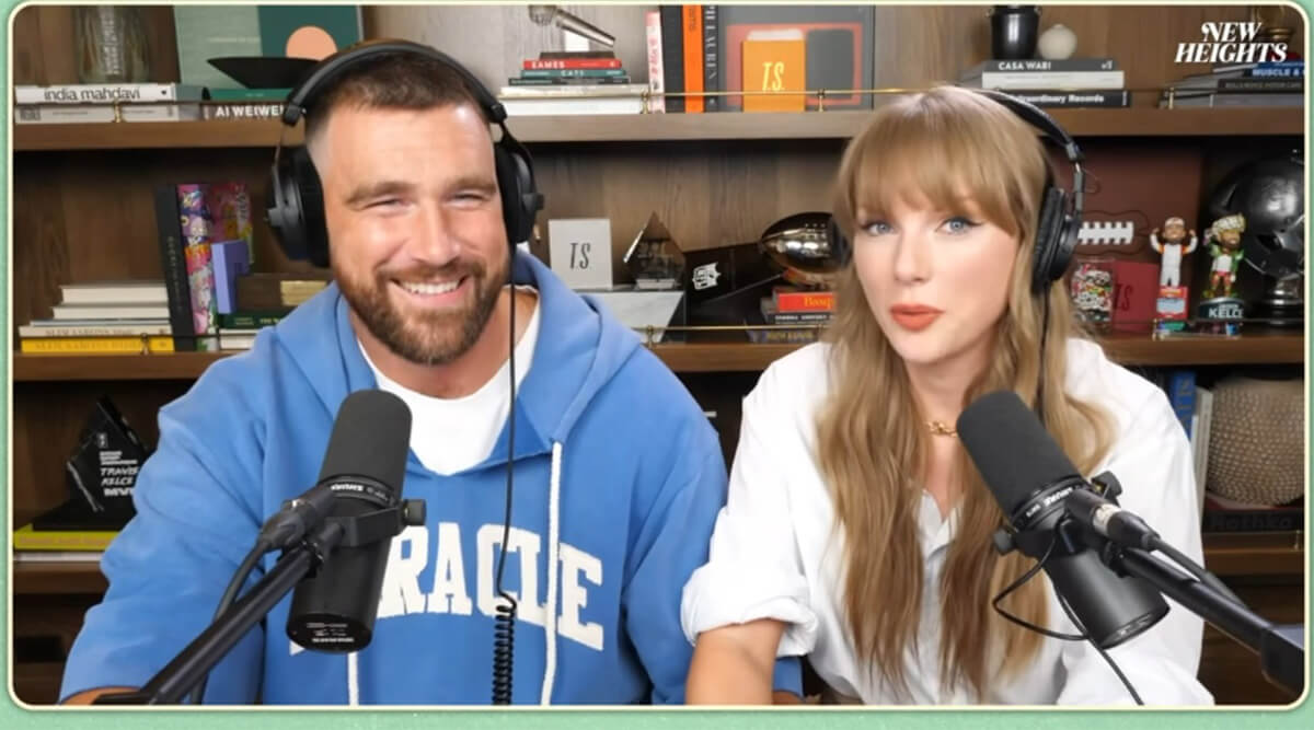 Travis Kelce and Taylor Swift smiling on New Heights podcast
