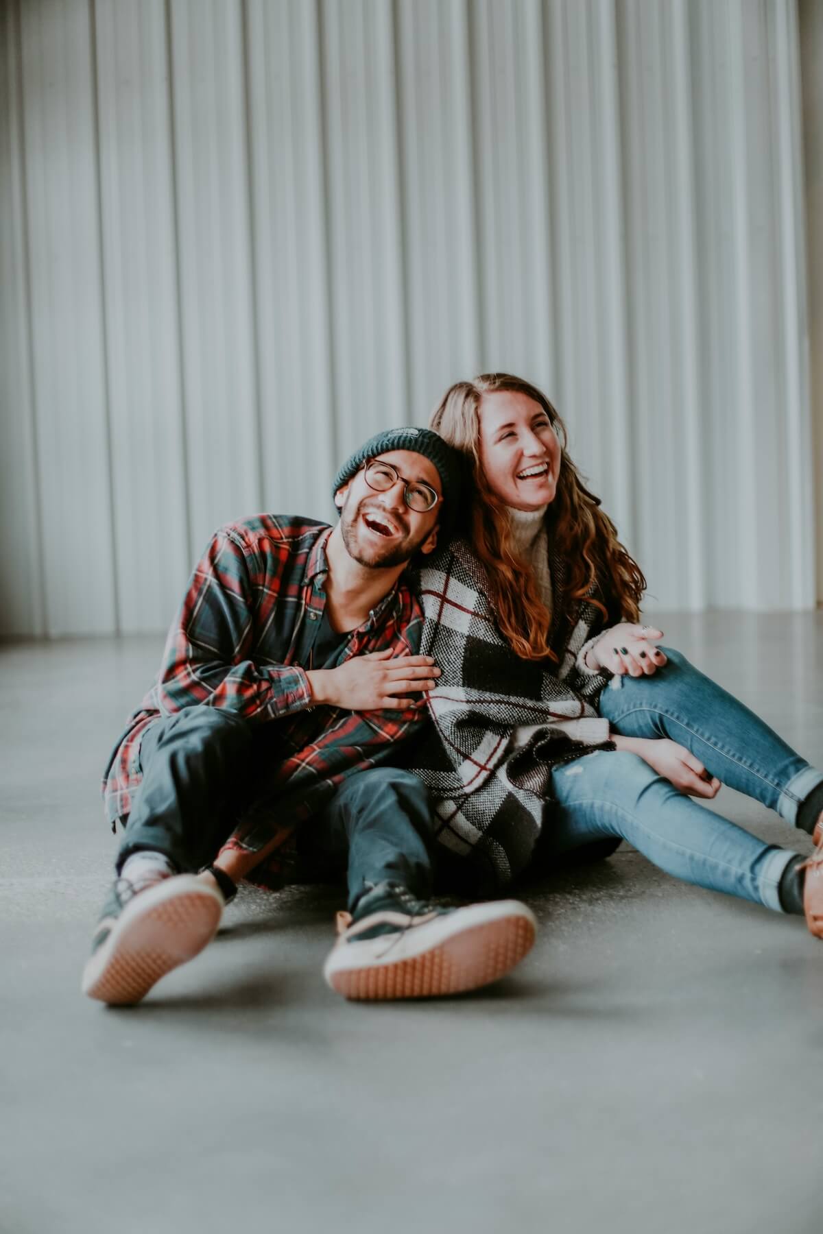 Unsplash: friends laughing together on floor by sarah noitner